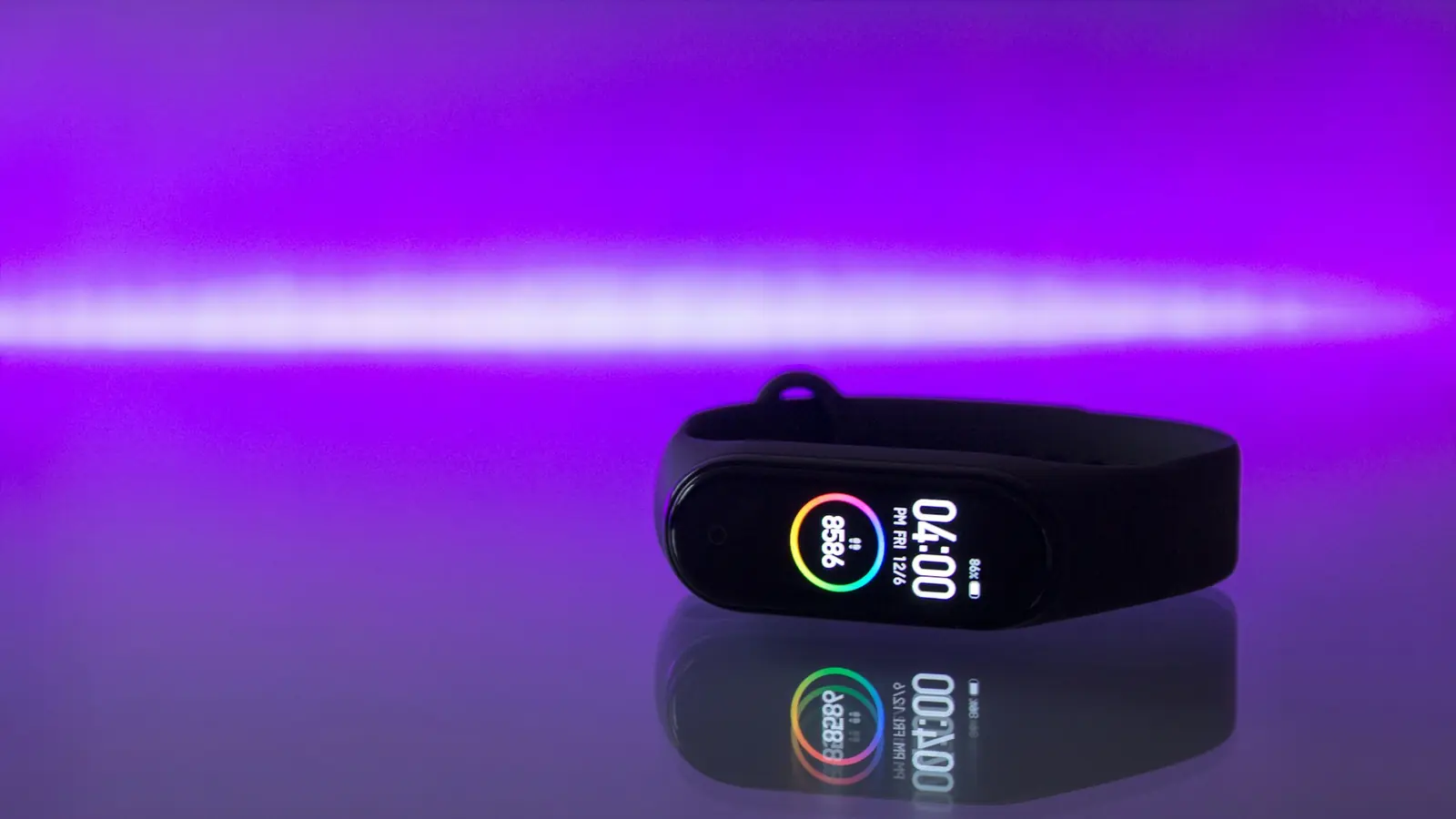 Black fitness tracker band showing health data