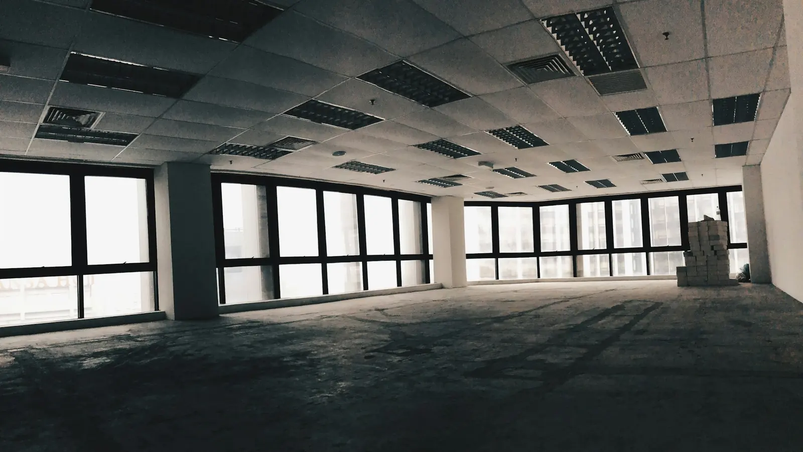 Empty office room with rows of unused desks