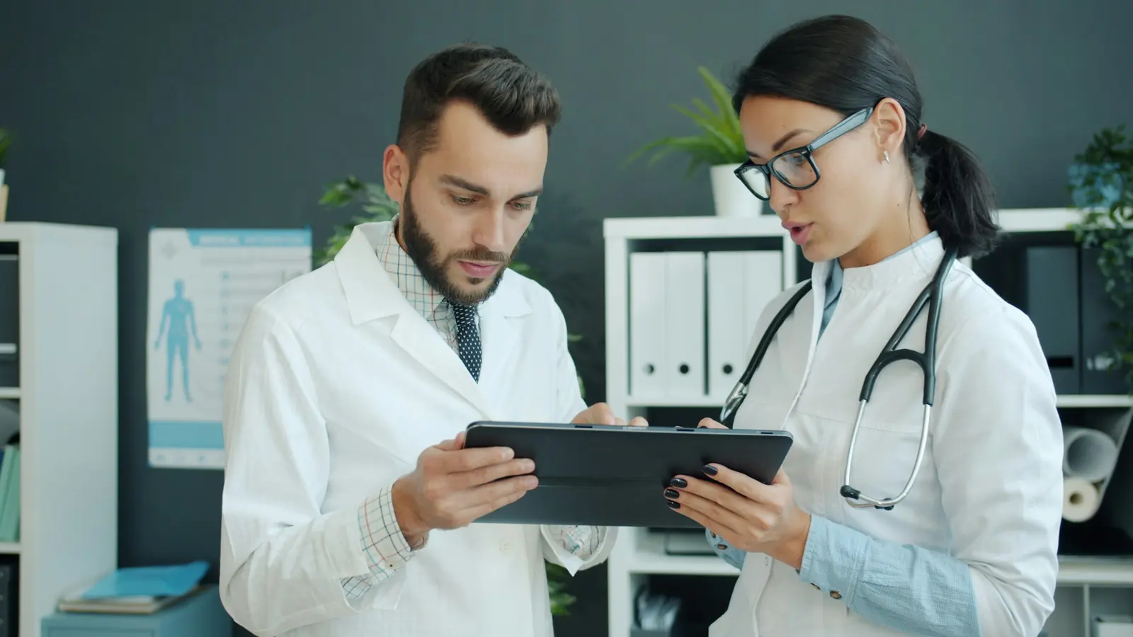 Two doctors reviewing patient data together on a tablet