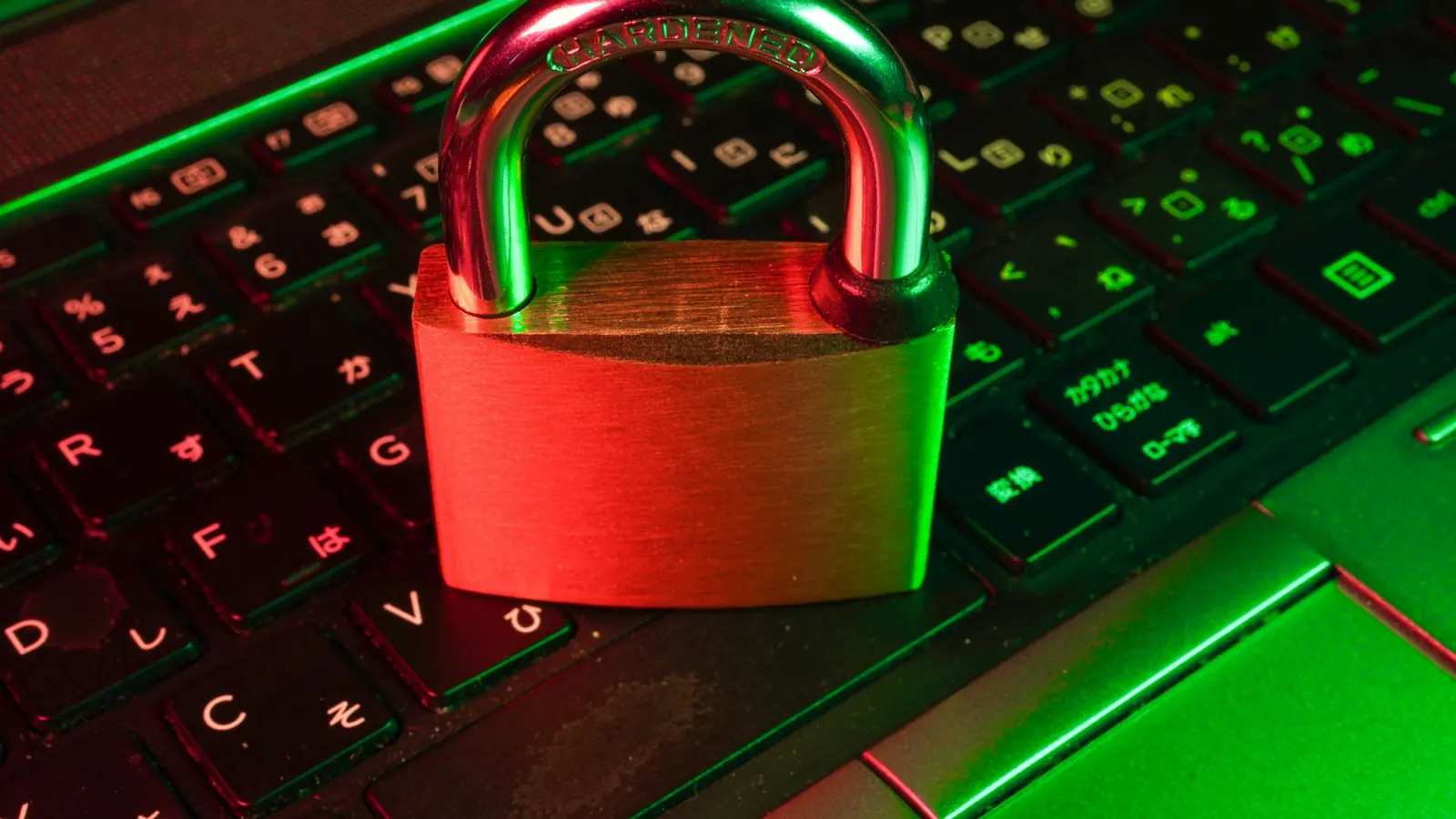 Red padlock resting on a black computer keyboard