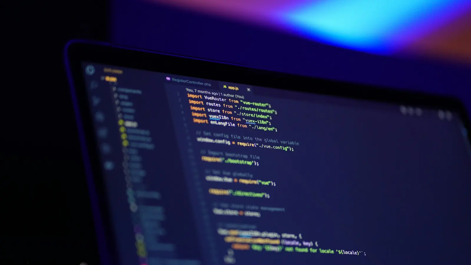 Laptop screen displaying colorful source code