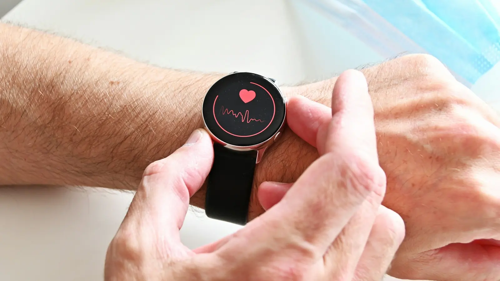 Person checking heart rate data on a smartwatch